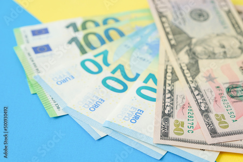 Euro money and american dollars on a colour paper background