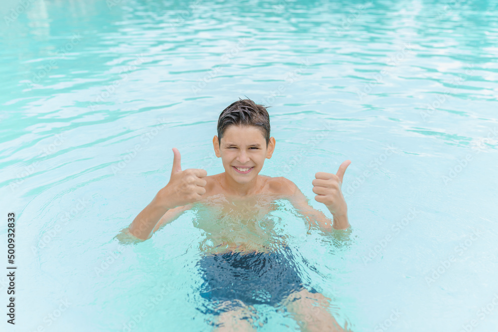 Happy child boy  in swimming pool. Summer vacation concept.