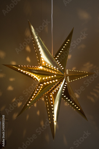 Golden star ornaments on Christmas tree