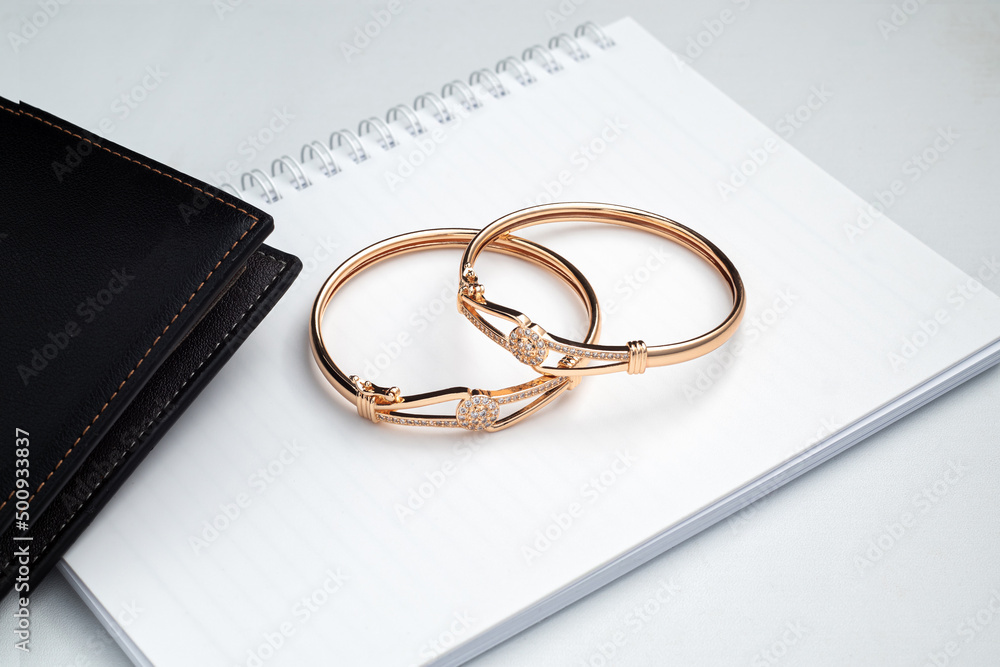 Gold bracelet on the office desk Gold bracelet on the office desk