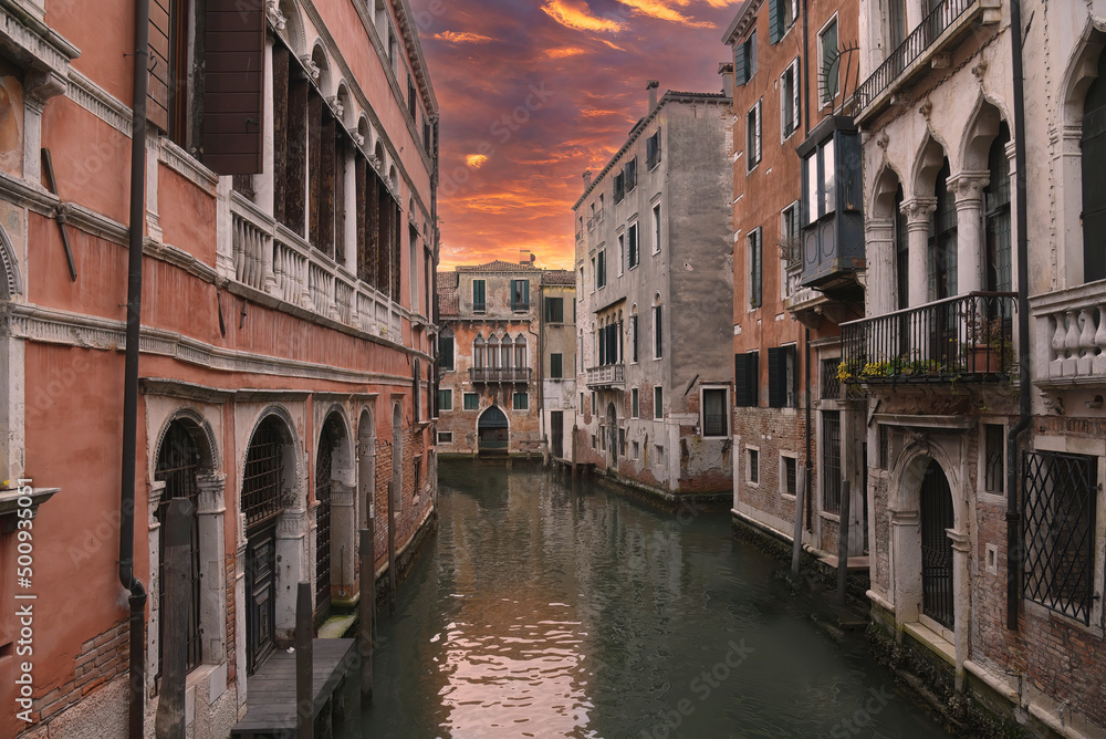 Canal en Venecia con un cielo rojo.
