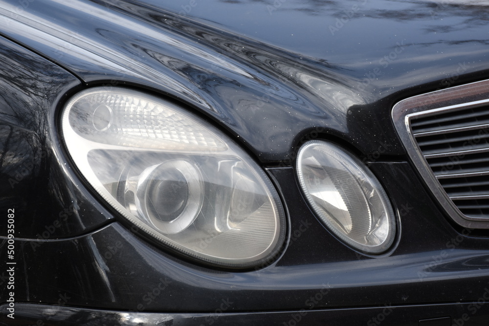 Car's exterior details.Blue car - headlight on a black  car