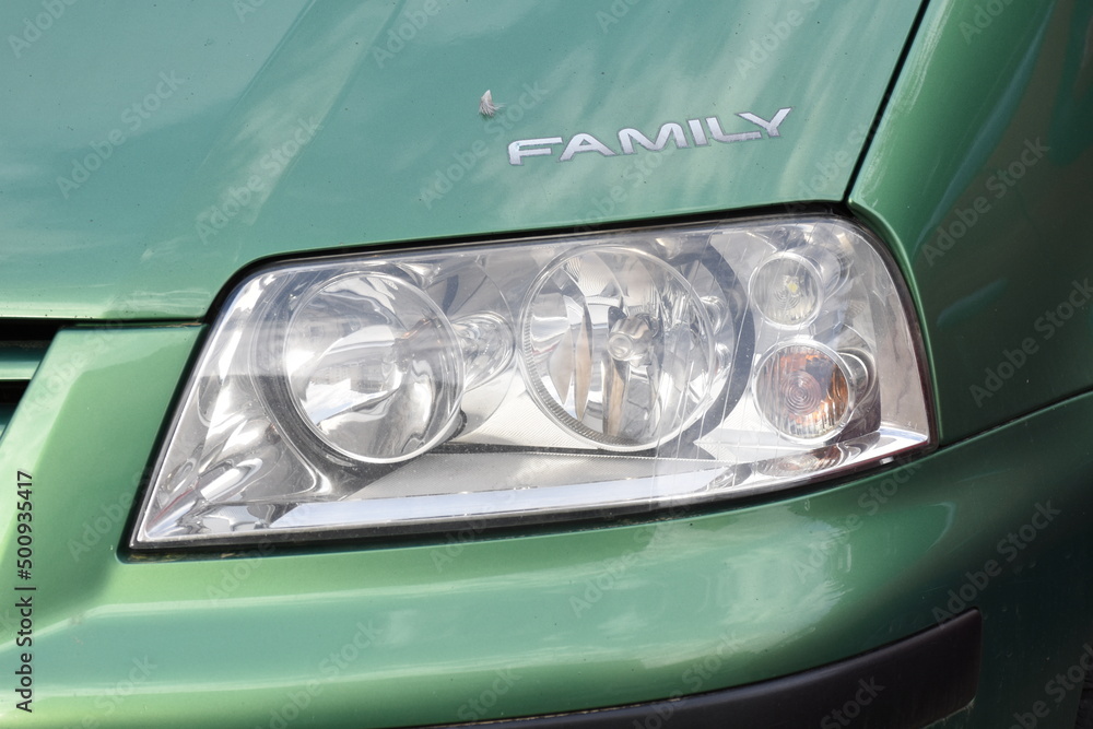 shiny headlight on a  green car