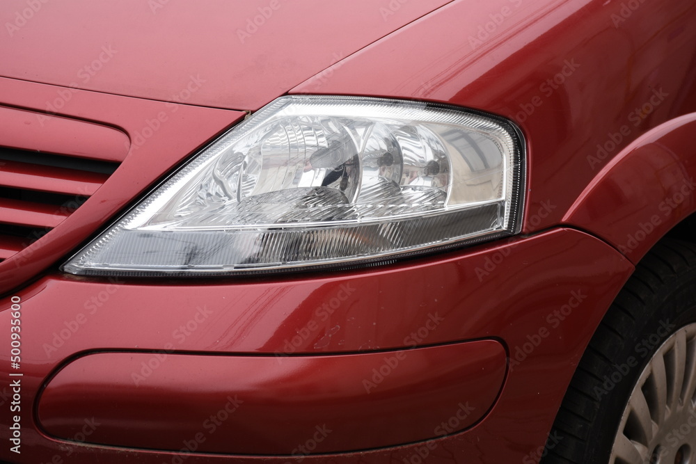 shiny headlight on a  red car