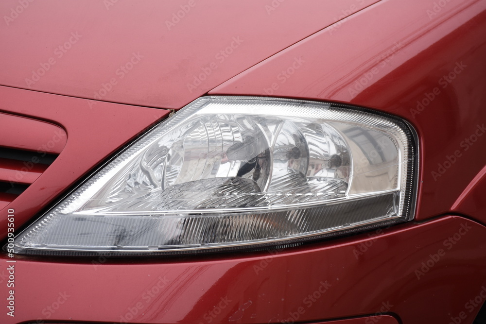 shiny headlight on a  red car