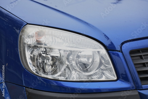 shiny headlight on a blue  car © Laurenx