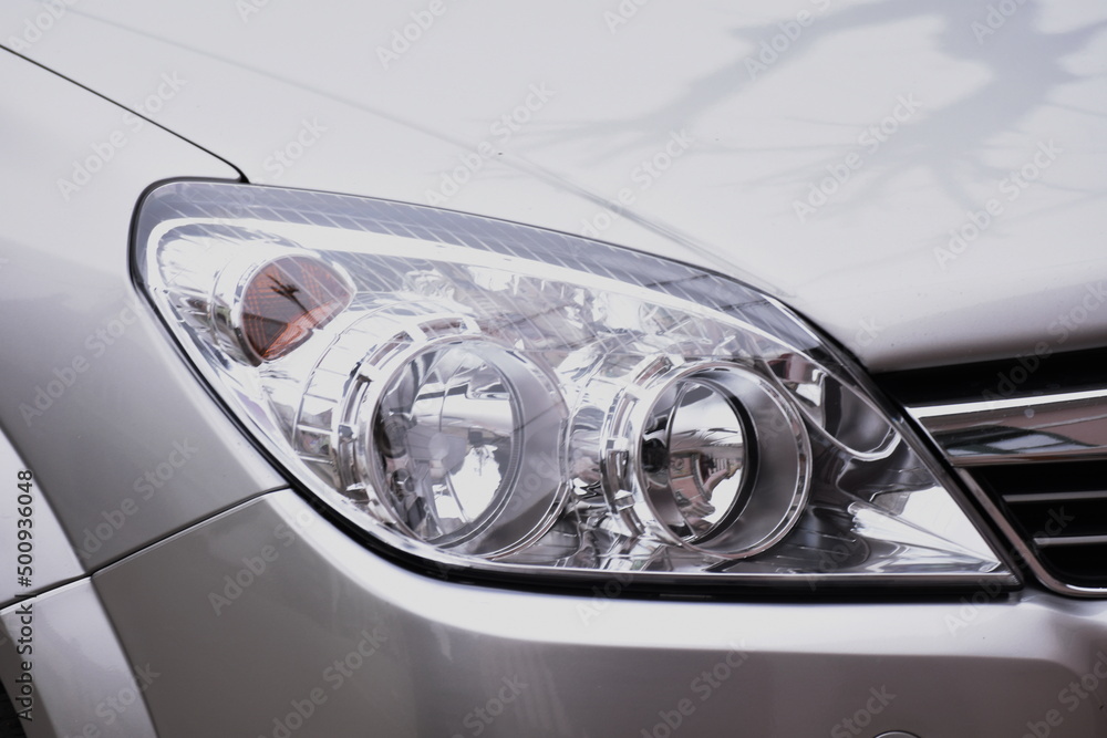 shiny headlights on a gray car