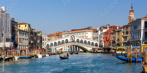 Venice Rialto bridge over Canal Grande with gondola travel traveling holidays vacation town panorama in Italy