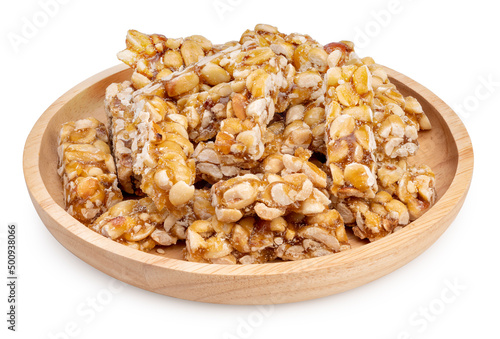 Nut Bars or Peanut Bar in wooden plate isolated on white background, Peanut Bar with Sesame seeds on white With clipping path.