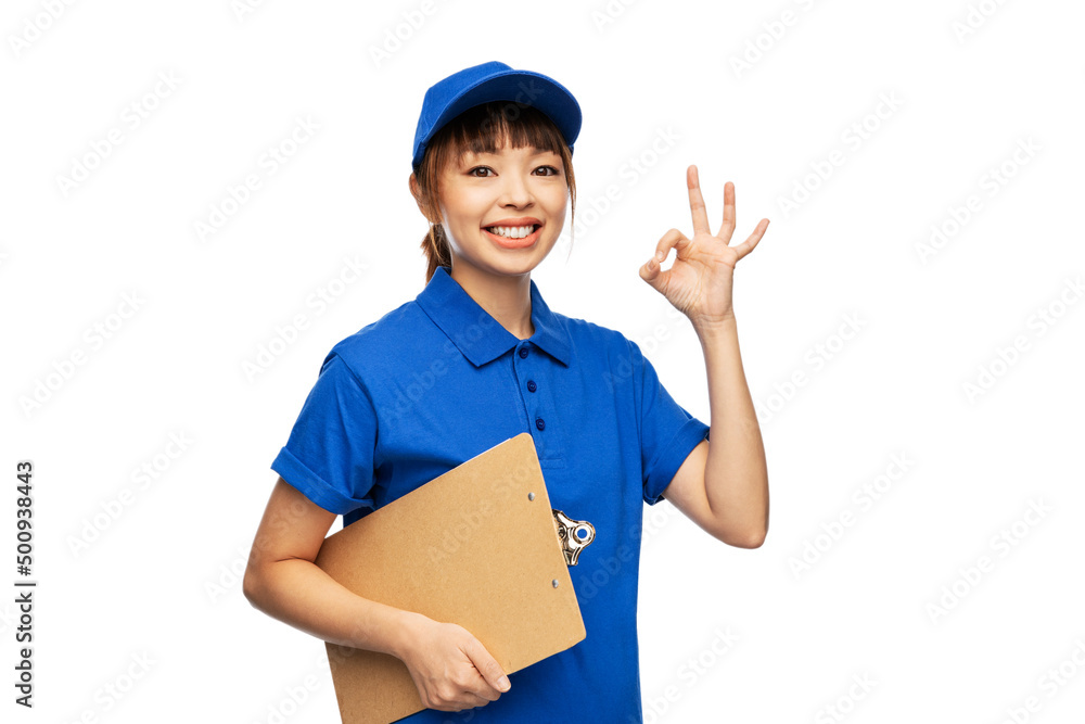 profession, job and people concept - happy smiling delivery woman in blue uniform with clipboard showing ok gesture over white background profession, job and people concept - happy smiling delivery woman in blue uniform with clipboard showing ok gesture over white background