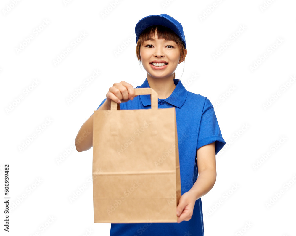 service and job concept - happy smiling delivery woman in blue uniform with takeaway food in paper bag over white background service and job concept - happy smiling delivery woman in blue uniform with takeaway food in paper bag over white background