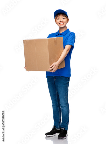mail service and shipment concept - happy smiling delivery woman with parcel box in blue uniform over white background