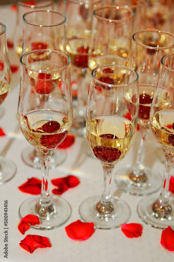 champagne glasses with cherries and red rose petals champagne glasses with cherries and red rose petals