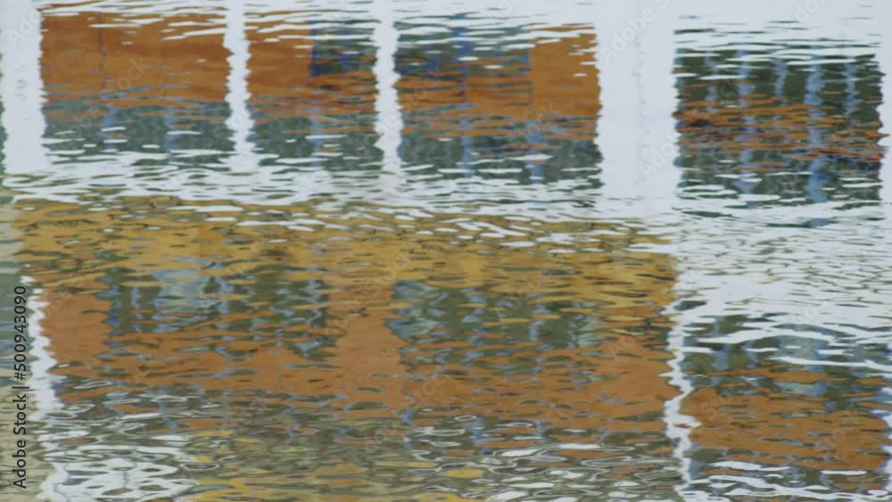 Beautiful reflections of colorful houses in the river. Yellow, red and white houses on the waterfront are reflected in the ripples of water. Walks in the medieval city. Girona. Catalunya. Spain.Europe Beautiful reflections of colorful houses in the river. Yellow, red and white houses on the waterfront are reflected in the ripples of water. Walks in the medieval city. Girona. Catalunya. Spain.Europe
