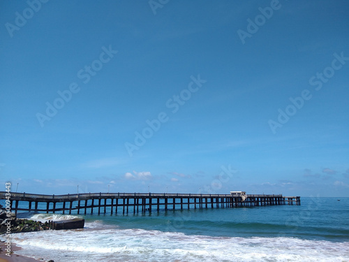 Fototapeta Naklejka Na Ścianę i Meble -  Valiyathura sea bridge, Thiruvananthapuram, Kerala, seascape view, blue sky background