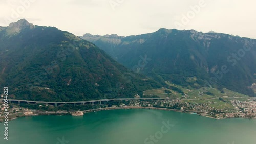 Aerial panorama of Leman Lake Geneva in Alps Mountains, Switzerland, canton of Vaud. Eastern end of lake, shore between Montreux and Villeneuve. 4K panning wide shot photo