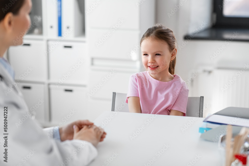 medicine, healthcare and pediatry concept - female doctor or pediatrician talking to happy smiling little girl patient on medical exam at clinic medicine, healthcare and pediatry concept - female doctor or pediatrician talking to happy smiling little girl patient on medical exam at clinic