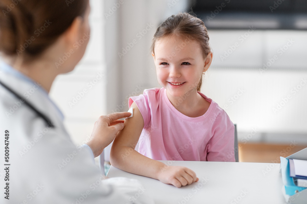 medicine, healthcare and vaccination concept - female doctor or pediatrician disinfecting arm skin of smiling little girl patient at clinic medicine, healthcare and vaccination concept - female doctor or pediatrician disinfecting arm skin of smiling little girl patient at clinic