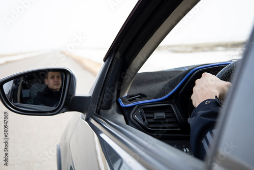 Man looking straight driving a car on the road