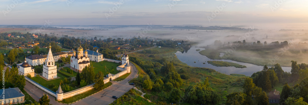 Panoramic aerial view of Luzhetsky Monastery and Moscow river on sunny summer morning. Mozhaysk, Moscow Oblast, Russia.