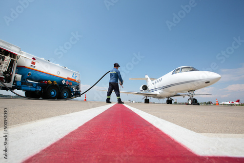 Refueling the jet plane at the airport