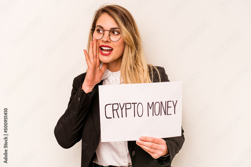 Young business caucasian woman holding a crypto money placard isolated on white background shouting and holding palm near opened mouth. Young business caucasian woman holding a crypto money placard isolated on white background shouting and holding palm near opened mouth.