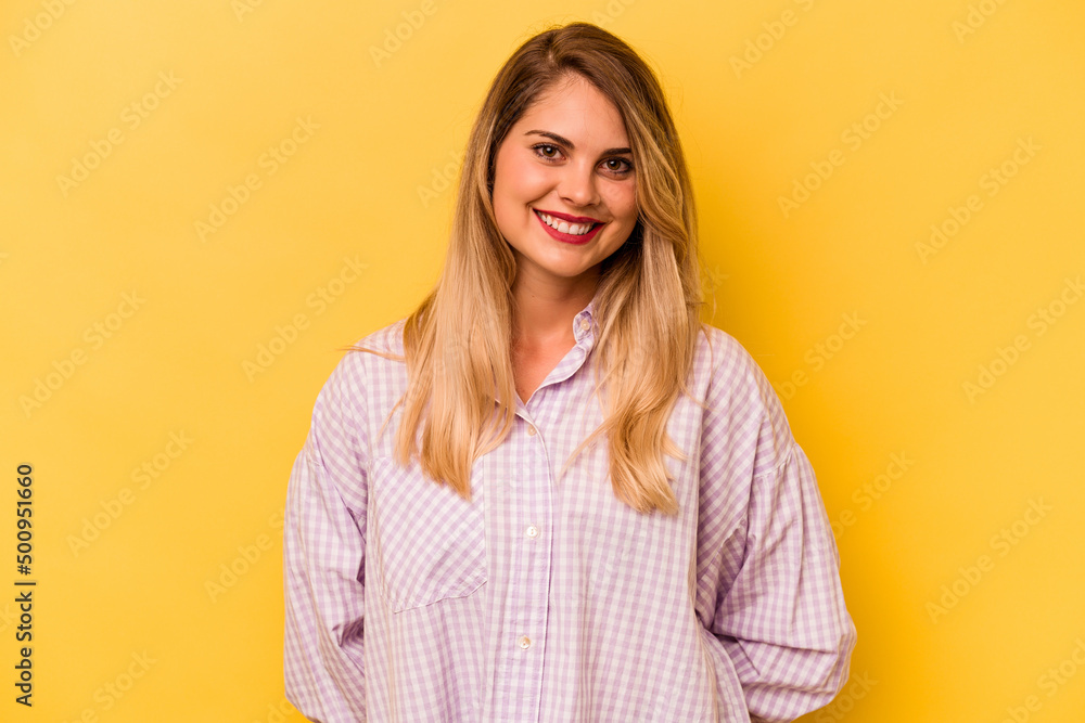 Young caucasian woman isolated on yellow background happy, smiling and cheerful. Young caucasian woman isolated on yellow background happy, smiling and cheerful.