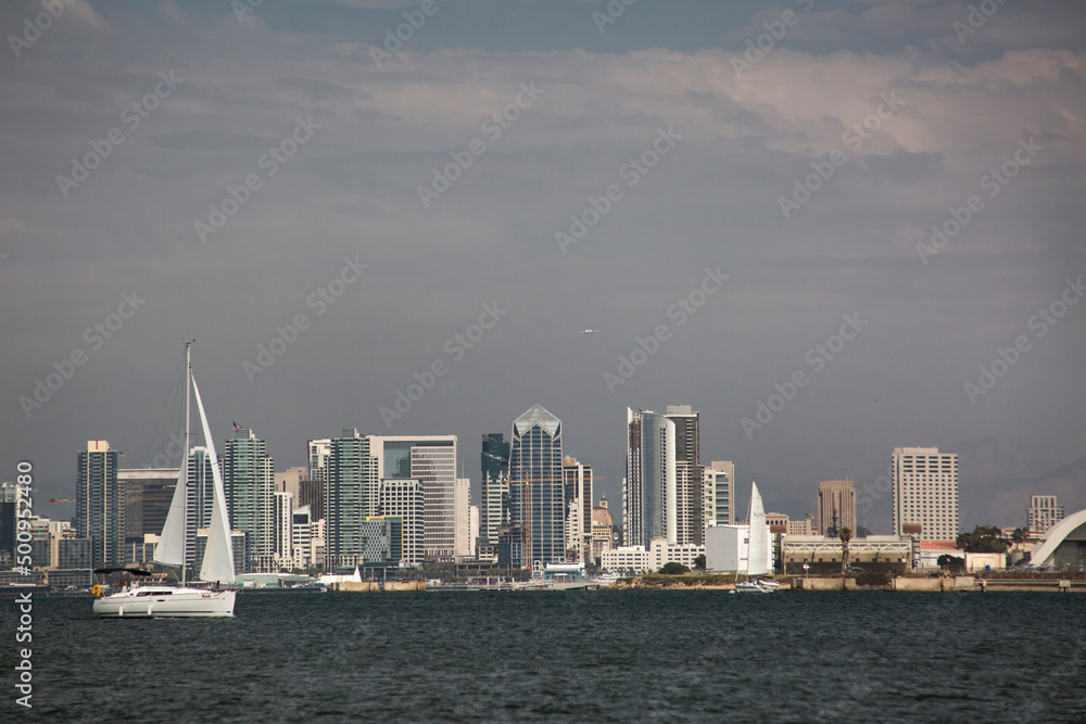 Panoramic view of San Diego skyline from the Bay with a sailing boat in the foreground Panoramic view of San Diego skyline from the Bay with a sailing boat in the foreground