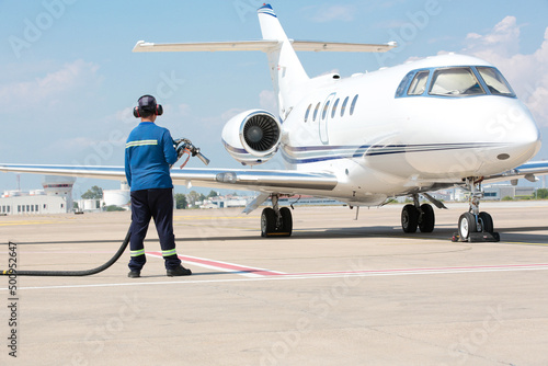 Refueling the jet plane at the airport