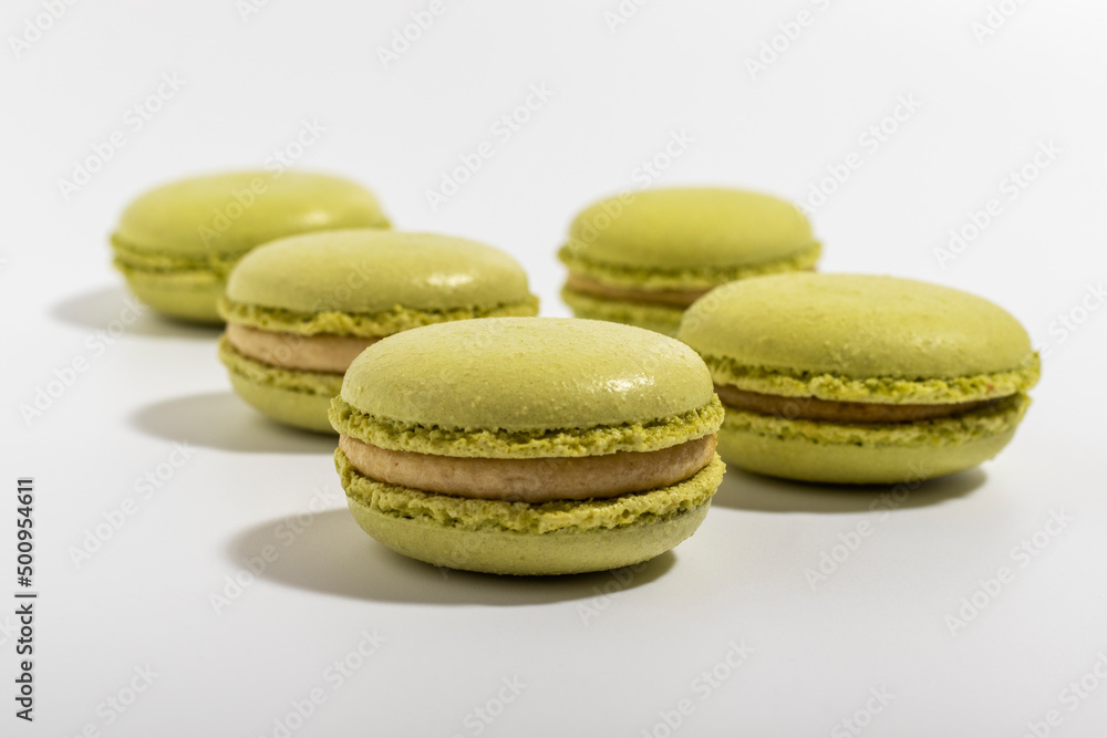 Pistachio Macarons on white background close-up. Pistachio Macarons on white background close-up.