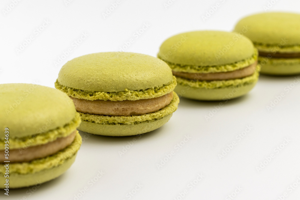 Pistachio Macarons on white background close up. Pistachio Macarons on white background close up.