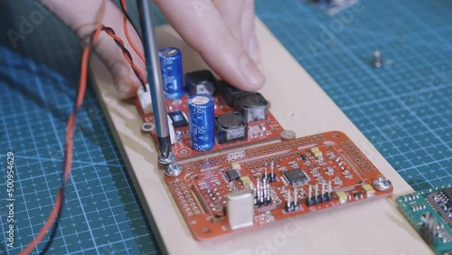 Male hands replace smd elements by soldering. Repair of electronic devices, tin soldering of parts. Repair of microcircuits with a soldering iron.