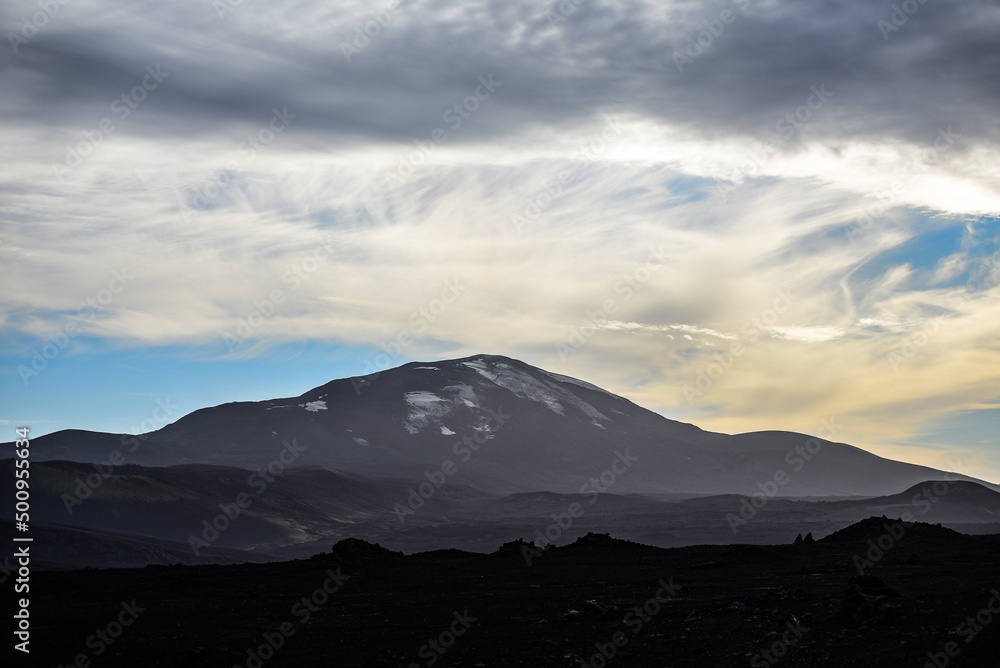 The ominous hulk of Hekla stratovolcano, one of Iceland's most active volcanoes, seen from the road from Landmannalaugar through the volcanic landscape of the Central Highlands of Iceland
