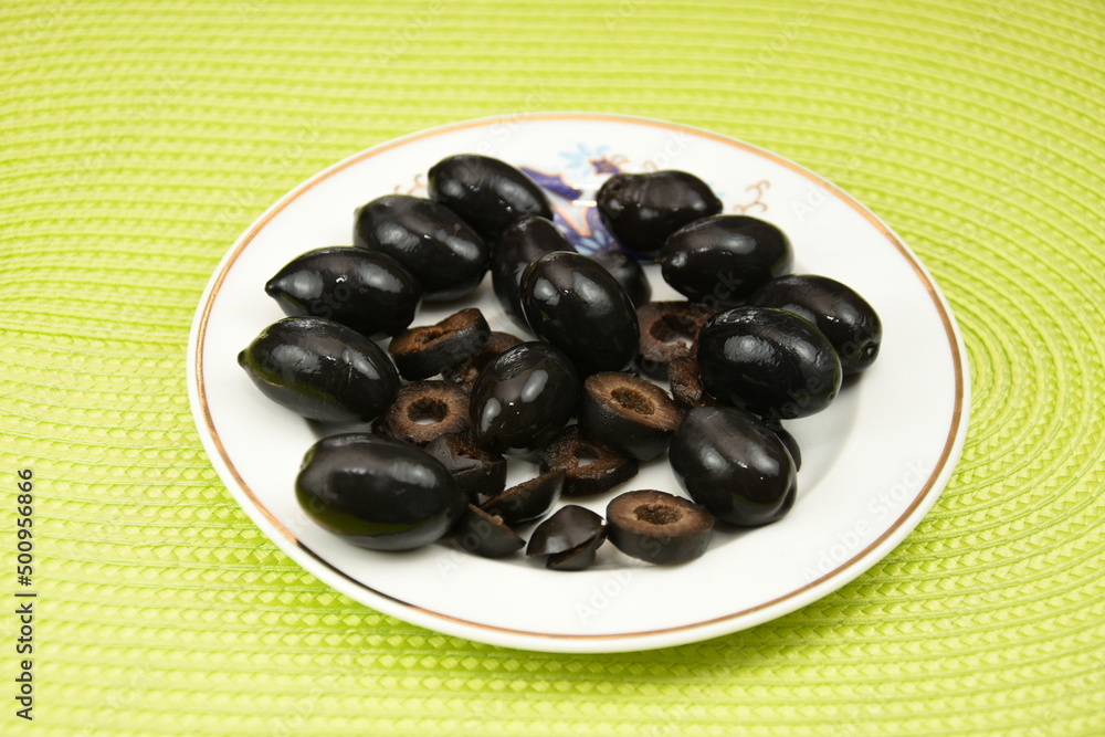 black olives on a porcelain plate black olives on a porcelain plate