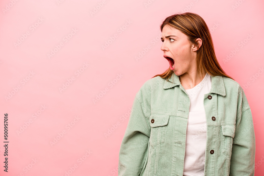 Young caucasian woman isolated on pink background shouting very angry, rage concept, frustrated. Young caucasian woman isolated on pink background shouting very angry, rage concept, frustrated.