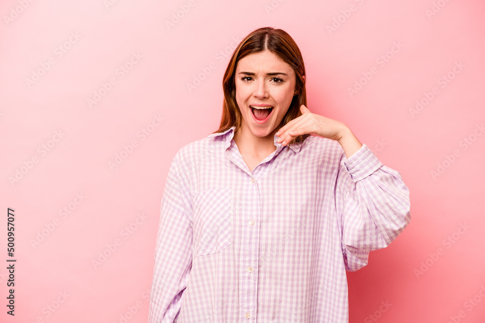Young caucasian woman isolated on pink background laughing about something, covering mouth with hands. Young caucasian woman isolated on pink background laughing about something, covering mouth with hands.
