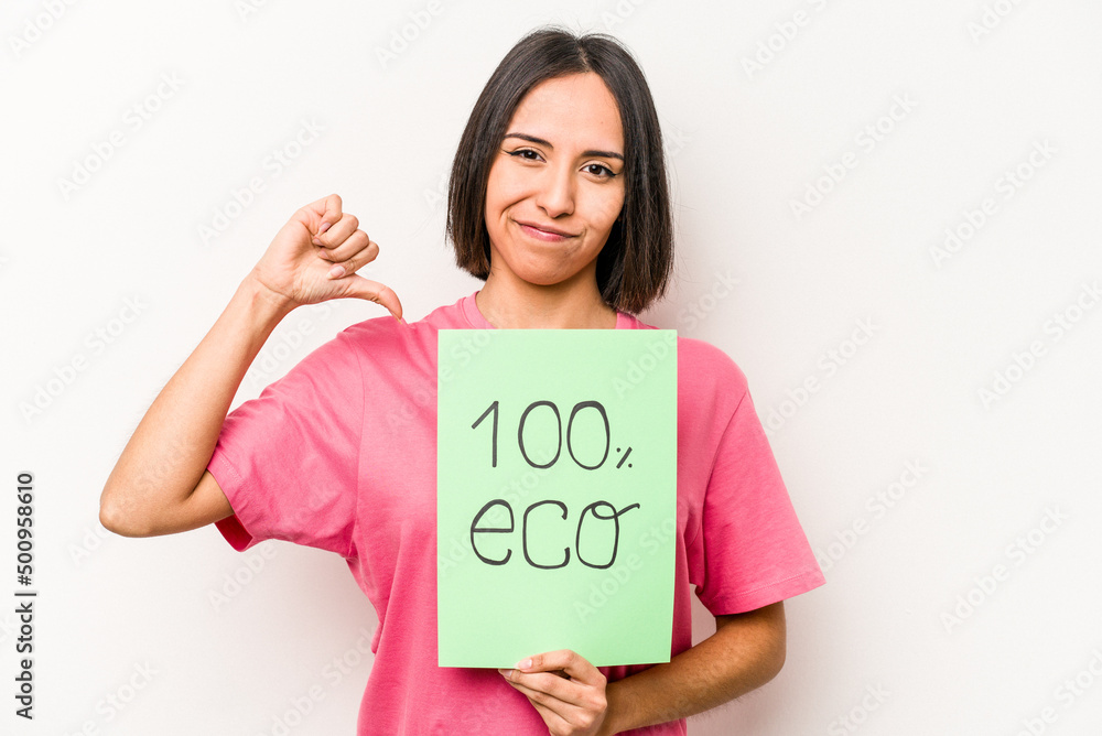 Young hispanic woman holding 100% eco placard isolated on white background feels proud and self confident, example to follow. Young hispanic woman holding 100% eco placard isolated on white background feels proud and self confident, example to follow.