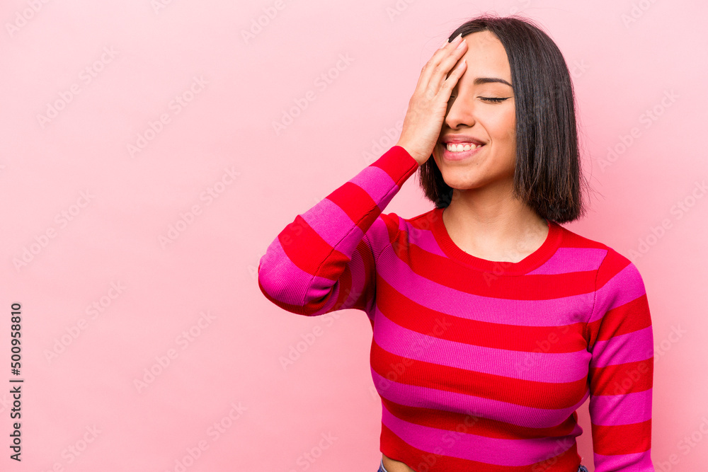 Young hispanic woman isolated on pink background laughing happy, carefree, natural emotion. Young hispanic woman isolated on pink background laughing happy, carefree, natural emotion.