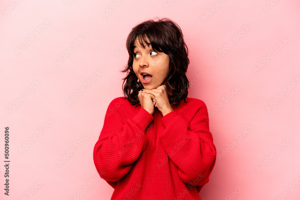 Young hispanic woman isolated on pink background praying for luck, amazed and opening mouth looking to front. Young hispanic woman isolated on pink background praying for luck, amazed and opening mouth looking to front.