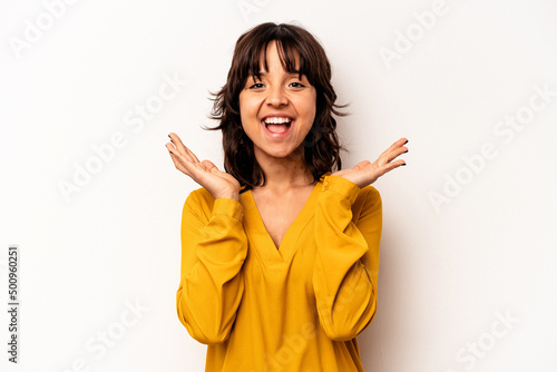Young hispanic woman isolated on white background laughs out loudly keeping hand on chest.