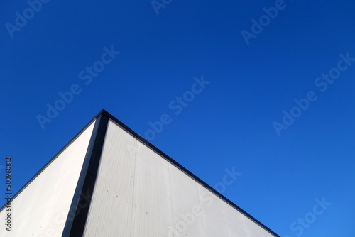 Commercial warehouse aluminium wall and roof against sky.