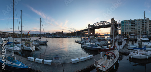Panoramic View of False Creek, Burrard Bridge, Boats in Marina in a modern city during sunset. Downtown Vancouver, British Columbia, Canada.