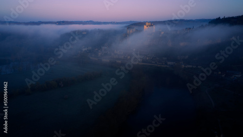 Chateaux Beynac in the mist, Dordogne - France © Luxiico
