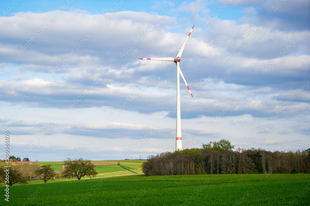 Panoramic view of wind farm or wind park on sunny day, with high wind turbines for generation electricity with copy space. Green energy concept. Panoramic view of wind farm or wind park on sunny day, with high wind turbines for generation electricity with copy space. Green energy concept.