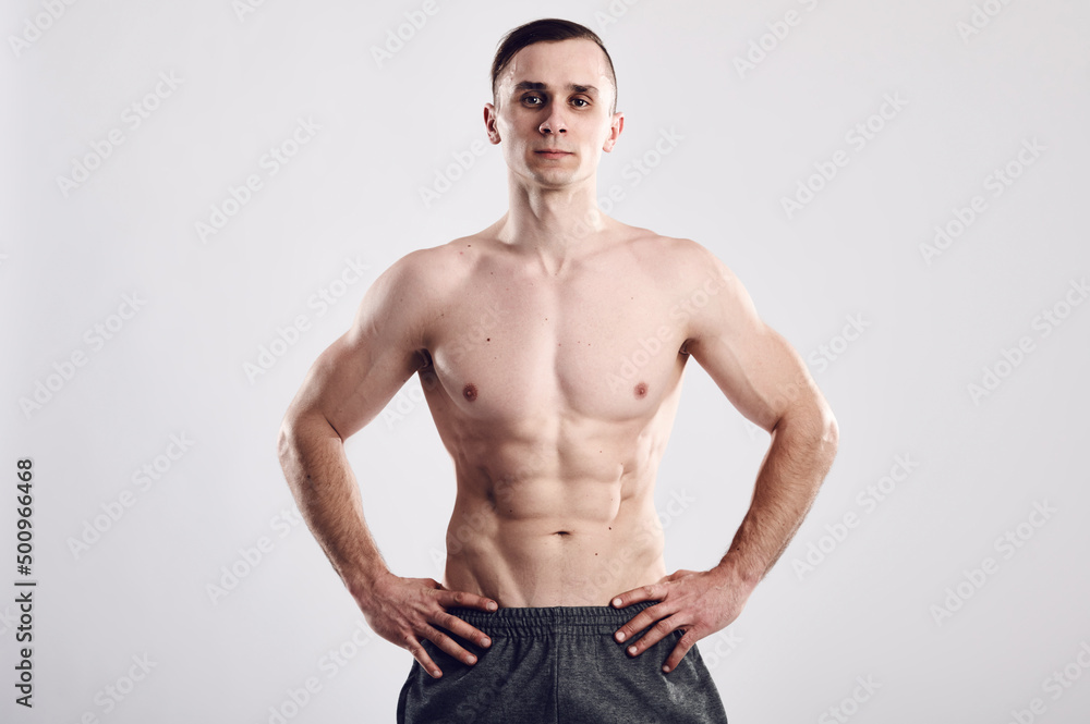 Strong sportsman with muscular abs and body on gray isolated background. Sport motivation. Healthy eating and lifestyle