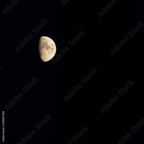 Waxing or waning moon against a clear black sky