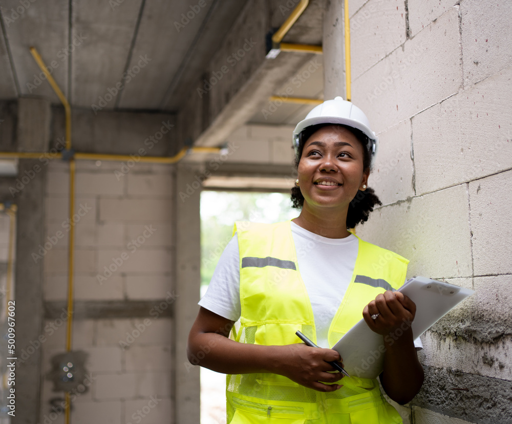 African American woman worker at construction site Wearing a hard hat