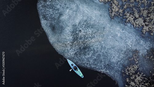 a board with a paddle in winter, top view