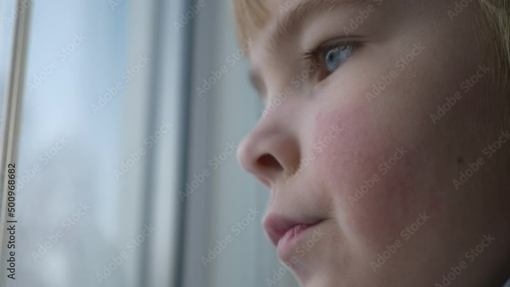 Sad Upset Little Boy Stands near Window. Thoughtful Lonely Kid Think Wait Miss. Child Wear Sweater. Winter Season Day. 2x Slow motion 60fps 4K Sad Upset Little Boy Stands near Window. Thoughtful Lonely Kid Think Wait Miss. Child Wear Sweater. Winter Season Day. 2x Slow motion 60fps 4K