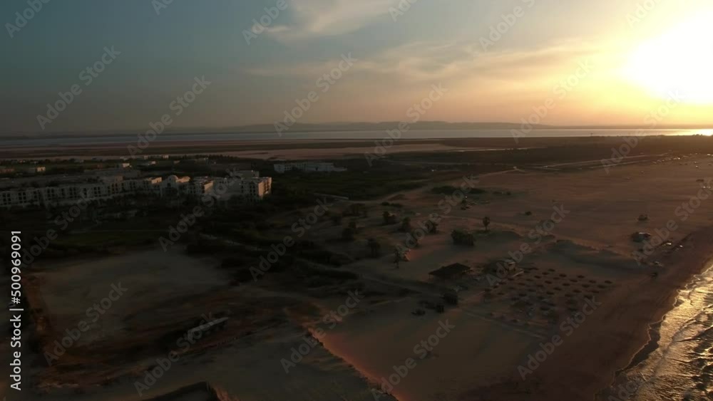 Aerial Panning Shot Of Hotel Buildings Against Sky During Sunset, Drone Flying Over Sea At Beach - Djerba, Tunisia Aerial Panning Shot Of Hotel Buildings Against Sky During Sunset, Drone Flying Over Sea At Beach - Djerba, Tunisia